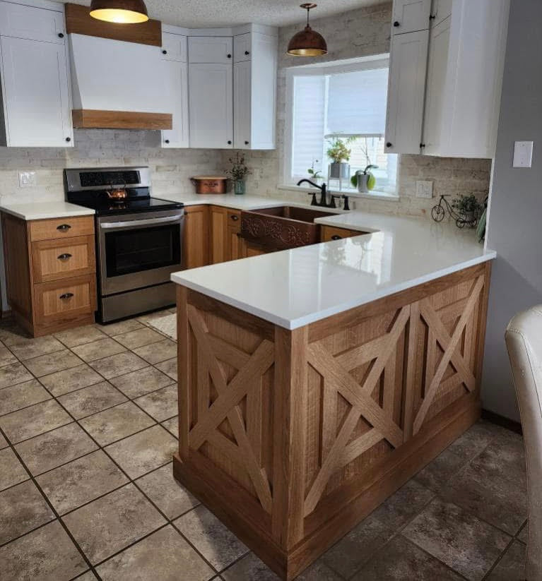 White kitchen with a wood island and decorative end panel