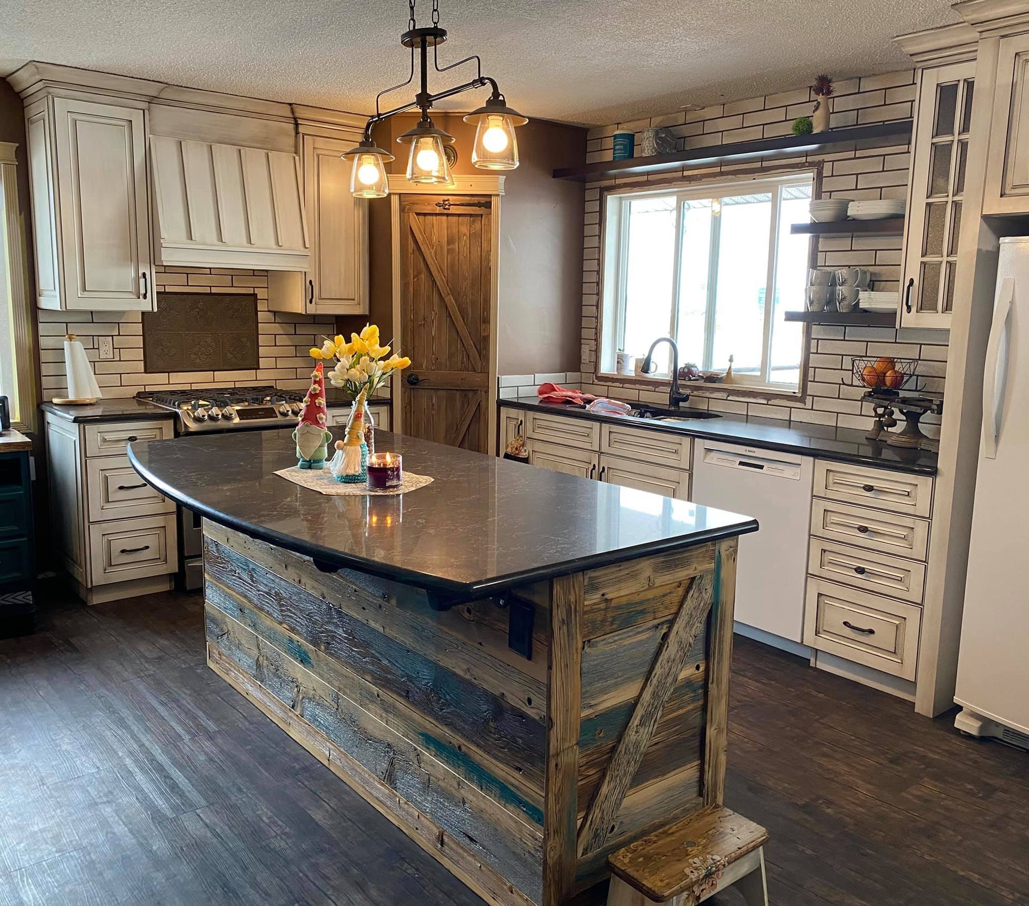 Traditional custom kitchen with decorative cabinetry and a stone accented island